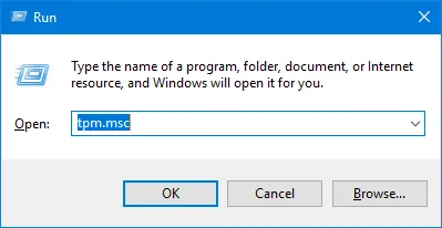 Windows Run dialog with tpm.msc typed in the Open field